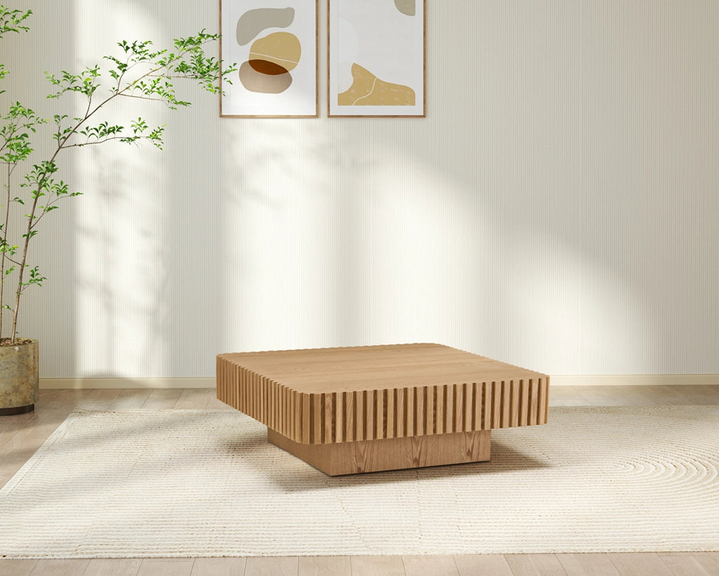 Wooden coffee table in a room with a plant and abstract wall art